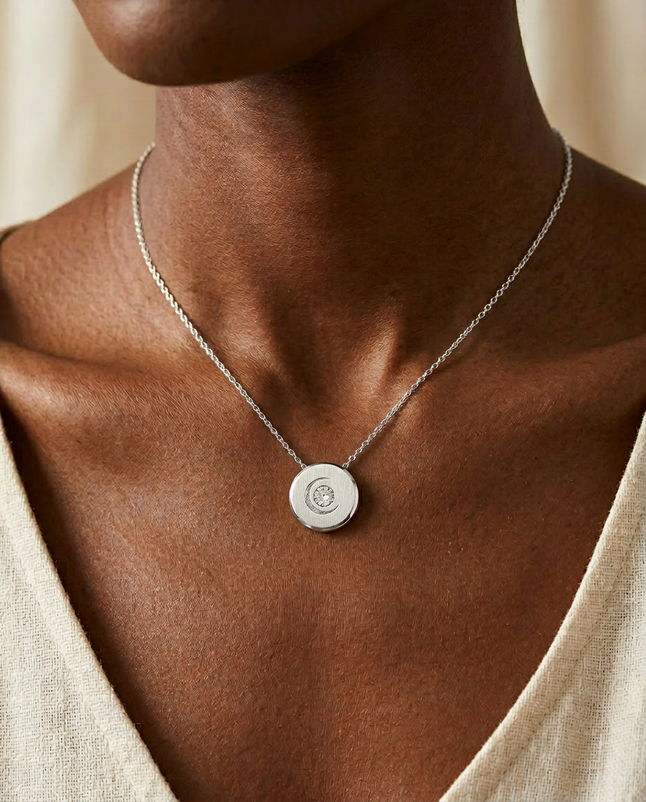 Lunar Necklace worn close to the heart in solid 14K white gold — brushed medallion with engraved crescent moon and lab-grown diamond